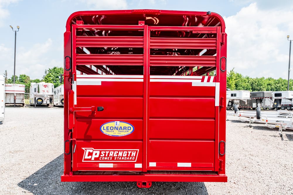 Rear view of a red livestock trailer with white stripes and CP Strength Comes Standard logo on the doors