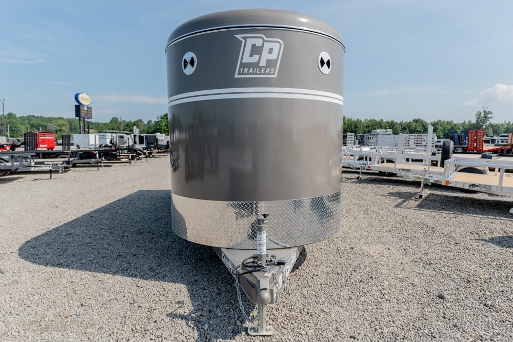 Grey pro trailer tank with CP Trailers logo, front hitch, and diamond plate trim on a gravel lot.