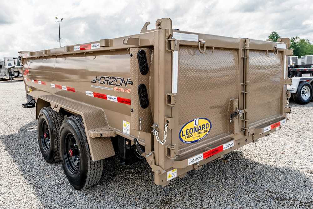 Side and rear view of a tan dual-axle Horizon dump trailer on a gravel lot, showing diamond-plate rear doors and Leonard logo on the back panel.