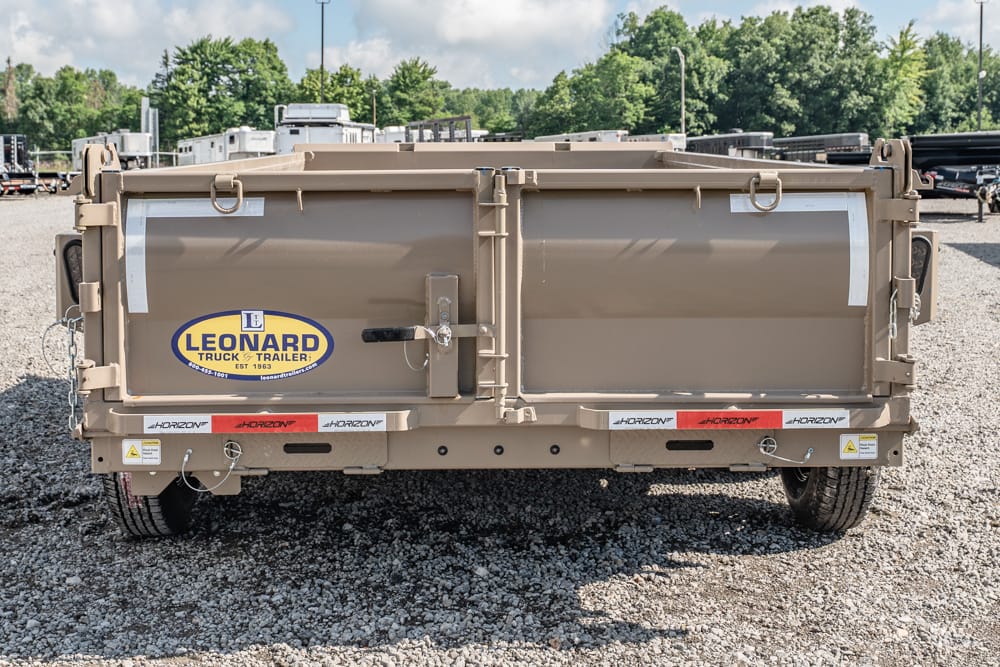 Rear view of a beige dual-compartment trailer with Leonard Truck & Trailer logo on the back doors.