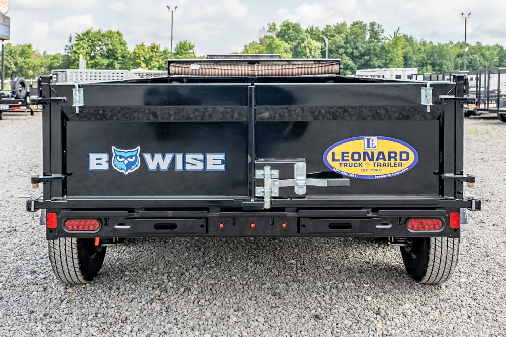 Black dump trailer back with BowWise logo and Leonard Truck & Trailer decal, set on a gravel lot.