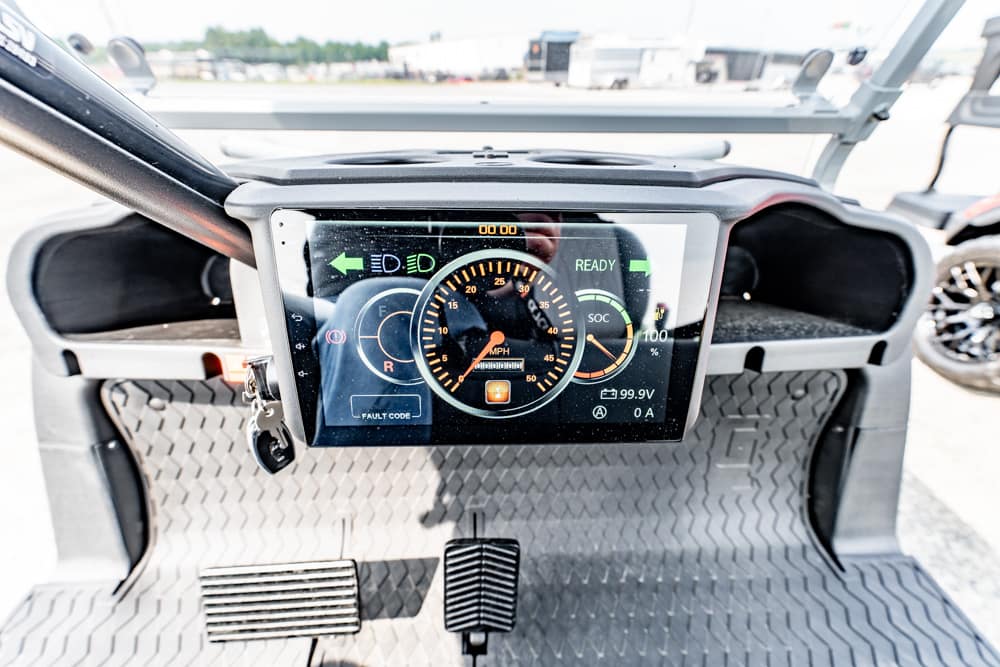 Close-up of a car's digital instrument cluster on a high-tech dashboard, with RPM gauge and readiness indicators visible.