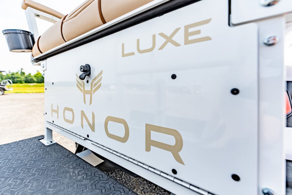 White service truck side panel with gold 'LUXE HONOR' lettering and winged logo.
