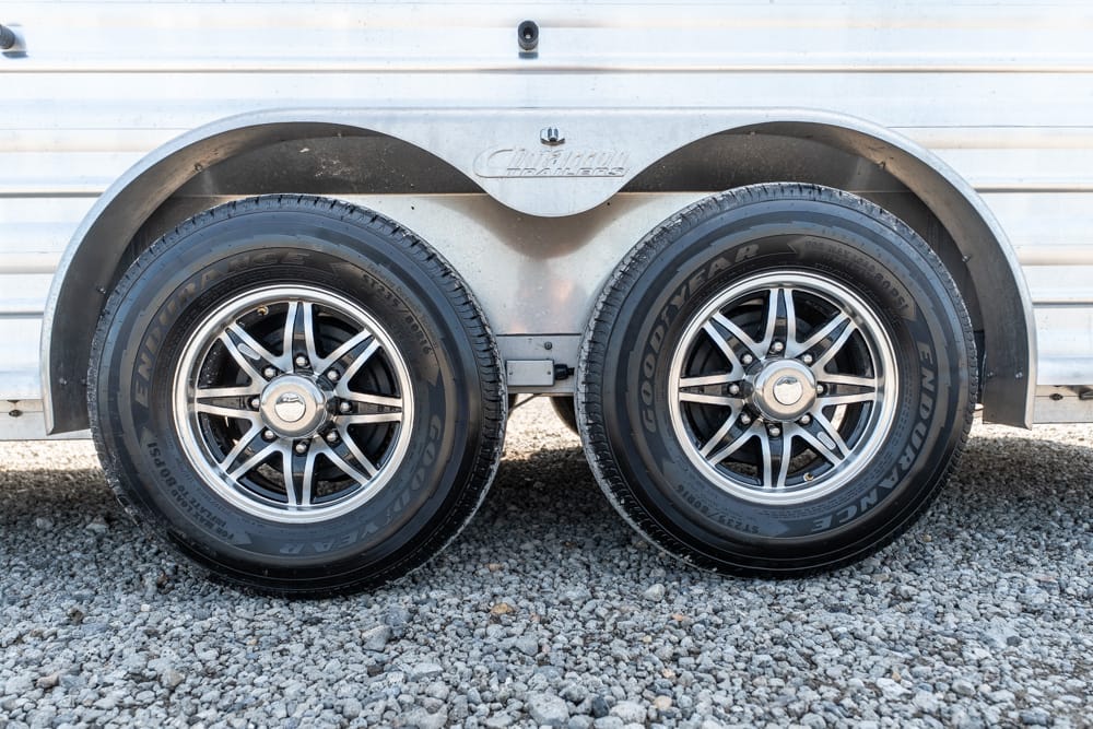 Dual trailer wheels with Goodyear Endurance tires mounted on silver rims under a metal trailer fender