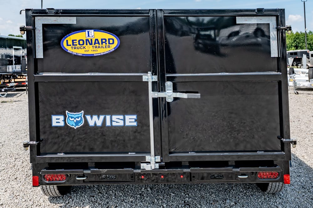 Back of a black dual-door trailer with BowWise logo and a Leonard Truck & Trailer sticker on the left door.