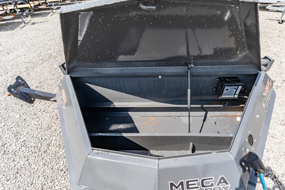 Open metal dump hopper with lid raised, showing interior storage and hydraulic strut, labeled Mega Boss on the sides.