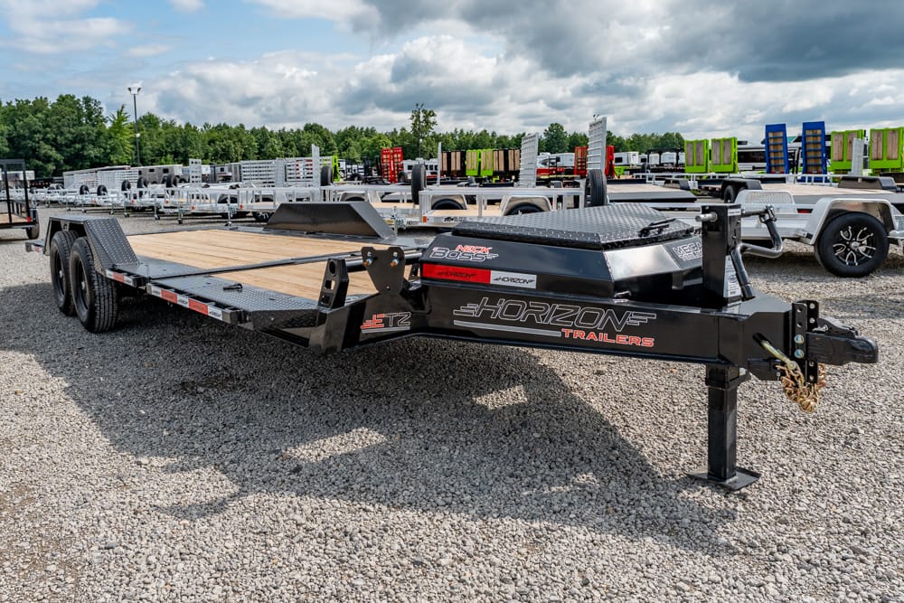 Horizon Trailers flatbed car trailer with wooden deck in a gravel lot.