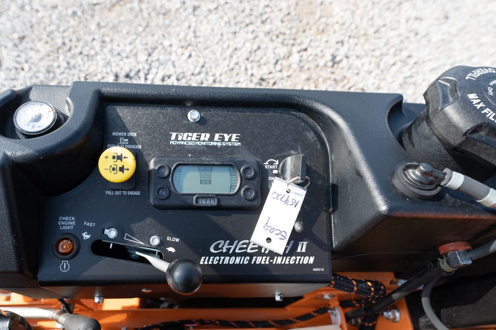 Close-up of a vehicle dashboard showing the Tiger Eye monitoring panel, digital display, ignition switch, and labels for fuel injection system.