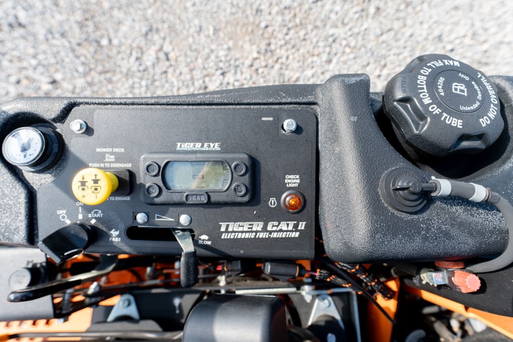 Snowmobile engine dashboard with Tiger Eye electronic fuel-injection panel, ignition knob, and digital display.