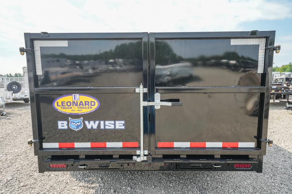 Back of a black dual-dump trailer with Leonard logo on the left door and BWISE text on the right door, plus red reflectors along the bottom edge.