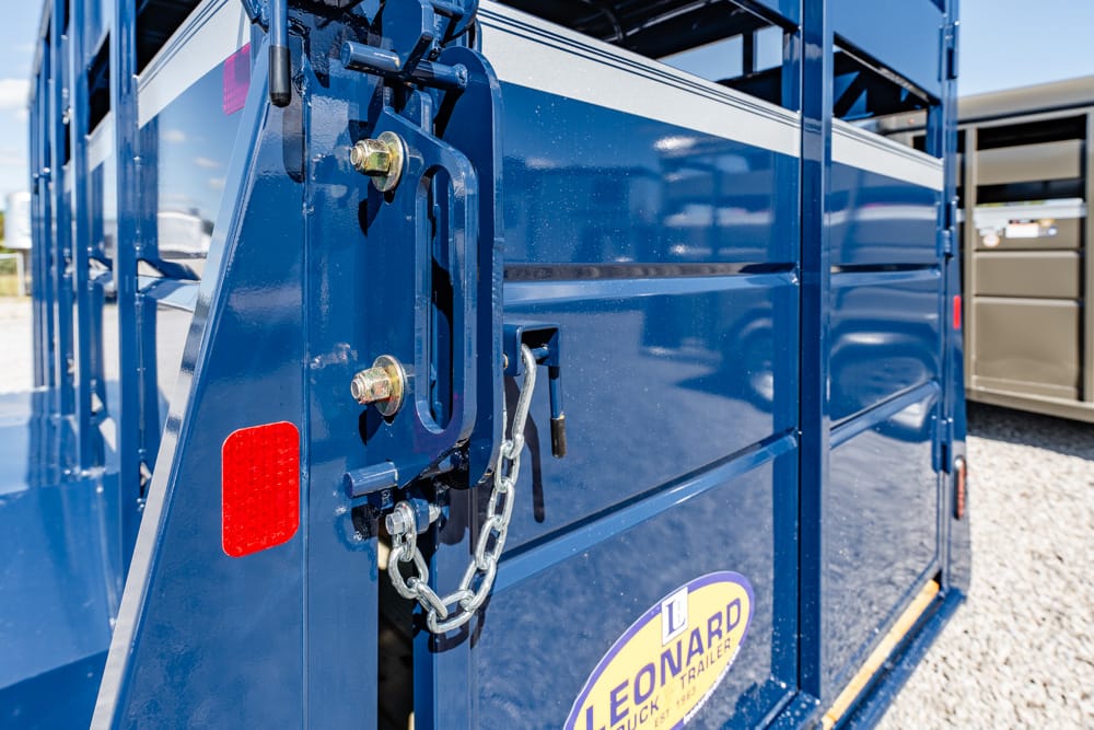 Close-up of a blue trailer rear latch with a metal chain and red reflector