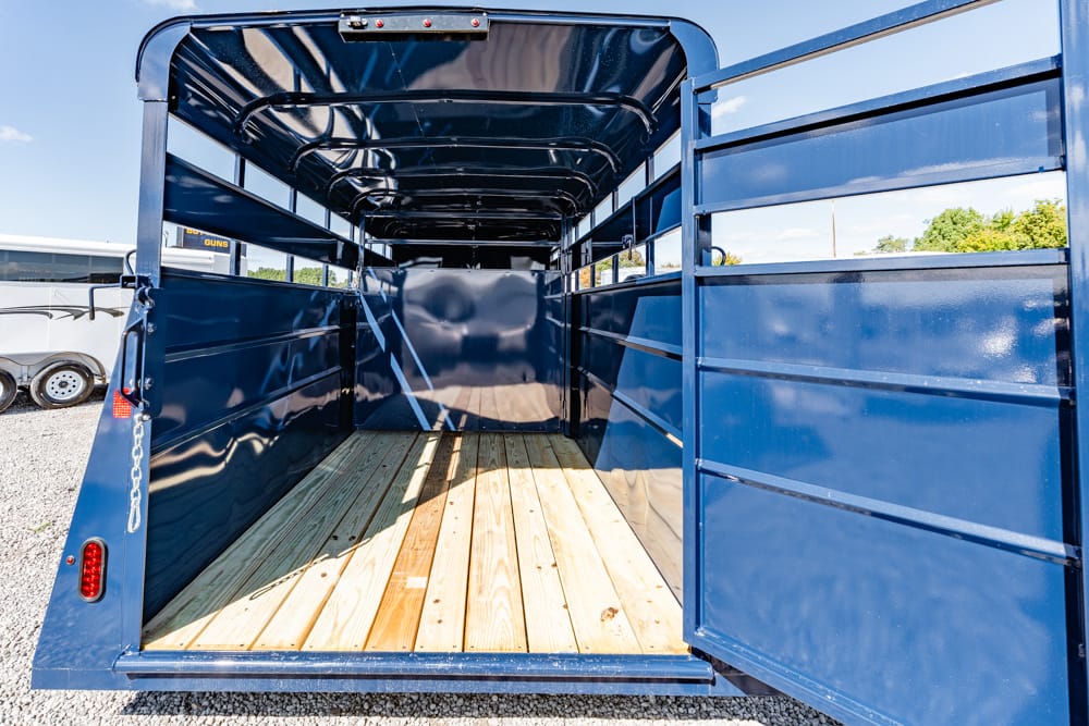Open blue trailer interior with wooden floor, view from the back doorway