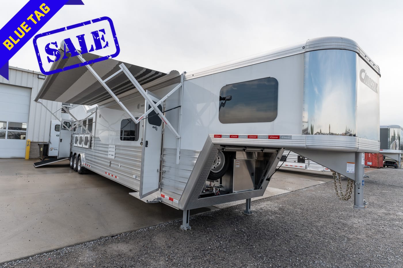 Fifth-wheel RV trailer on sale, with a blue 'SALE' stamp and a blue 'BLUE TAG' banner in the top-left corner.
