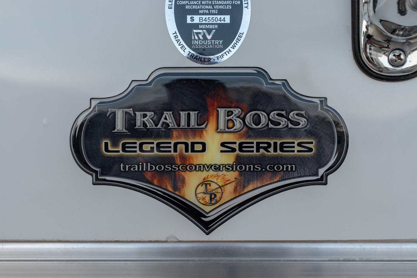 Tailgate badge reading 'Trail Boss Legend Series' with a fiery design and the website trailbossconversions.com