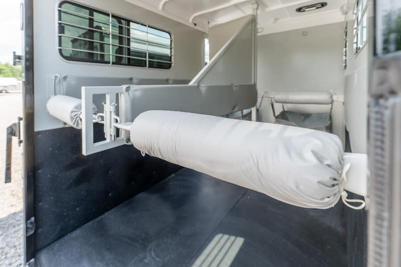Interior of a veterinary transport trailer with a fold-out padded stretcher secured to the wall