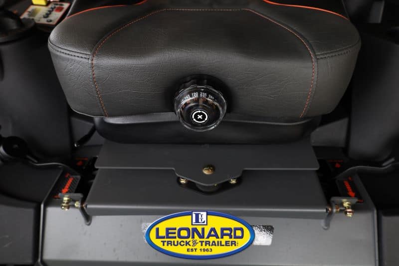 Close-up of a vehicle seat with a chrome, numbered adjustment knob for backrest angle; Leonard Truck & Trailer logo visible below.