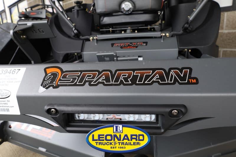 Front view of a Spartan zero-turn mower deck, showing the orange SPARTAN logo and a Leonard Truck & Trailer badge.